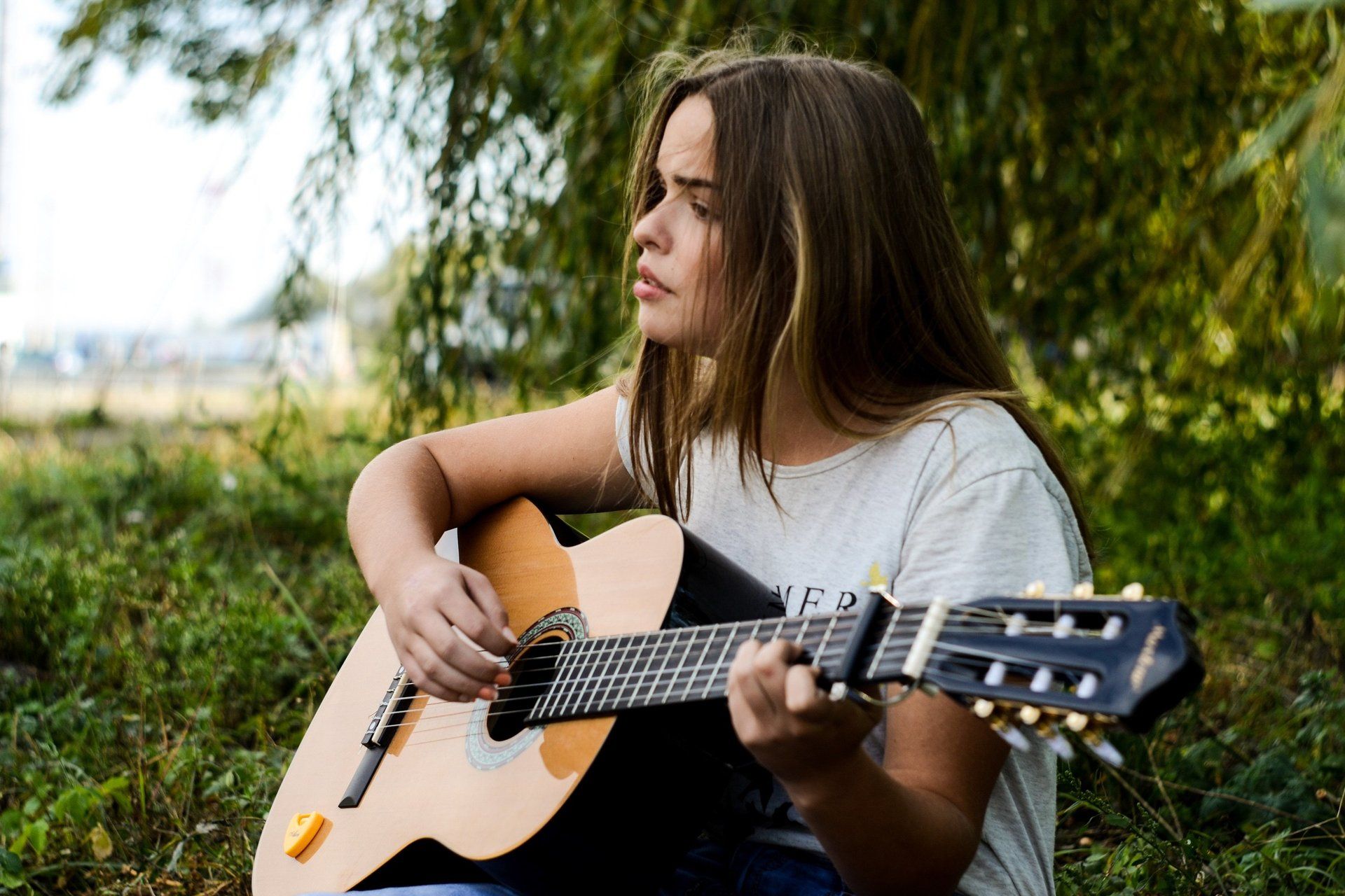 Close-up of hands playing an acoustic guitar